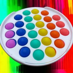 Circle Rainbow fidget popper made with durable nontoxic silicone
